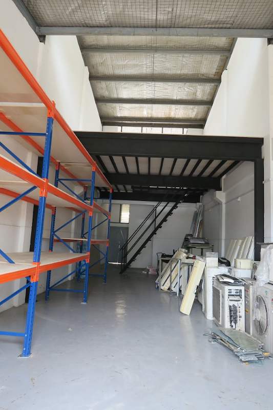 Racking run along the wall with plywood decking, mezzanine and stored air-conditioning units at the back - V3000 Racking - V3-2 | Wong Lye Racking, Singapore Racking Manufacturer
