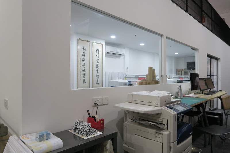Office area under the mezzanine with a glass-fronted room, desks and a printer - V5000 Racking - V5-13 | Wong Lye Racking, Singapore Racking Manufacturer