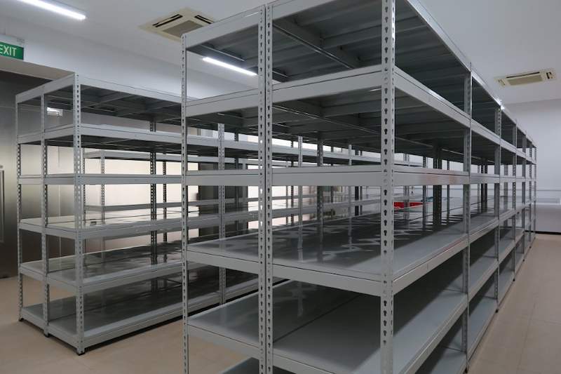 Boltless shelving bays with five shelf levels in the corner of the tiled room - Boltless Racking - B5 | Wong Lye Racking, Singapore Racking Manufacturer