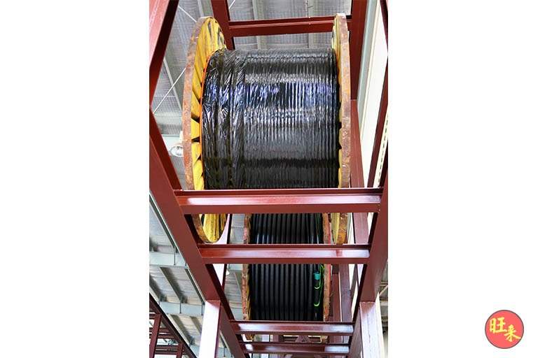 Cable drum held in the red-oxide primed steel frame of the racking, viewed from below - V10000 Racking - V10-1 | Wong Lye Racking, Singapore Racking Manufacturer