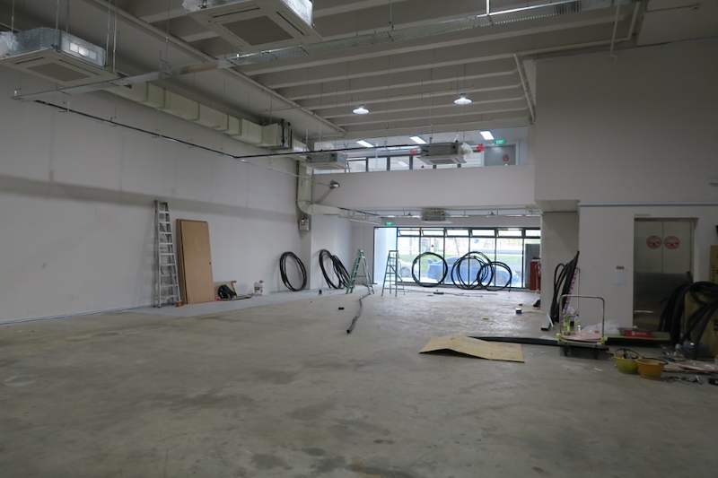 Before: bare unit looking toward the glass frontage, cable coils and ladder on the floor - Boltless Racking - B8 | Wong Lye Racking, Singapore Racking Manufacturer