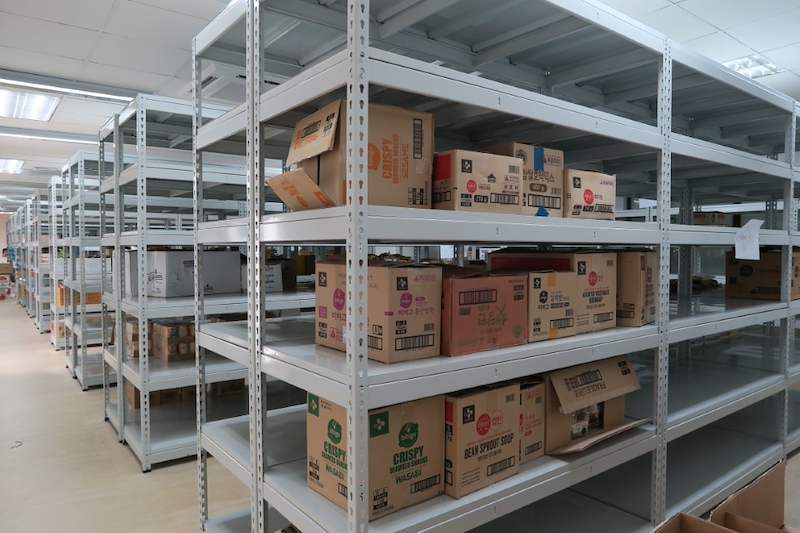 Cartons of packaged goods on the shelves of a boltless shelving bay - Boltless Racking - B2 | Wong Lye Racking, Singapore Racking Manufacturer