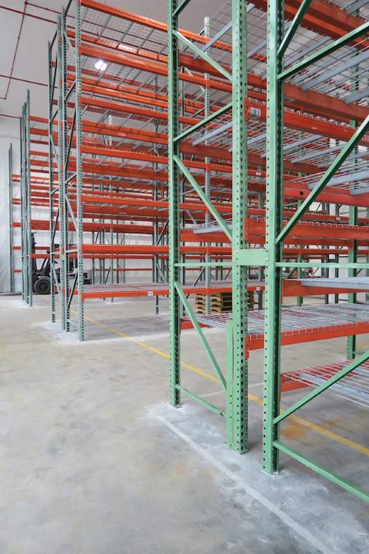 Green upright frame and orange beams of the pallet racking at the end of an aisle - V3000 Racking - V3-3 | Wong Lye Racking, Singapore Racking Manufacturer
