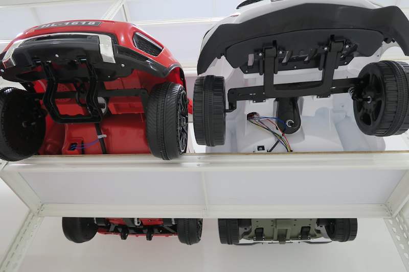 Underside view of two ride-on toy cars on a boltless shelf, showing the shelf board from below - Boltless Racking - B3 | Wong Lye Racking, Singapore Racking Manufacturer