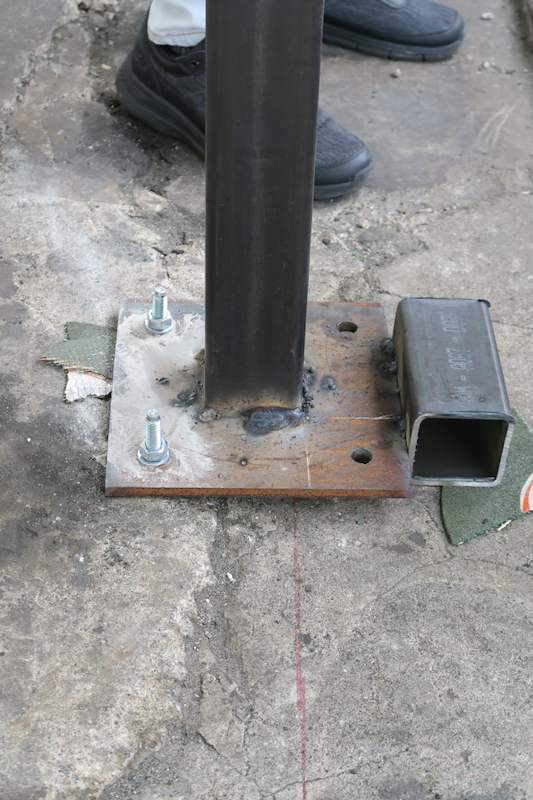 Steel upright welded to a base plate with anchor bolts, close view at floor level - V5000 Racking - V5-1 | Wong Lye Racking, Singapore Racking Manufacturer