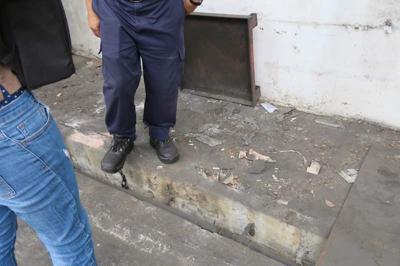 Steel base plate positioned on the concrete kerb where the rack will stand, installer alongside - V5000 Racking - V5-1 | Wong Lye Racking, Singapore Racking Manufacturer