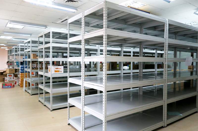 Grey boltless shelving blocks in the store with cartons of stock at the end of the row - Boltless Racking - B2 | Wong Lye Racking, Singapore Racking Manufacturer