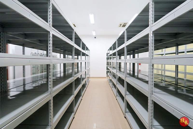 Central aisle between rows of grey boltless shelving, shelves empty - Boltless Racking - B5 | Wong Lye Racking, Singapore Racking Manufacturer