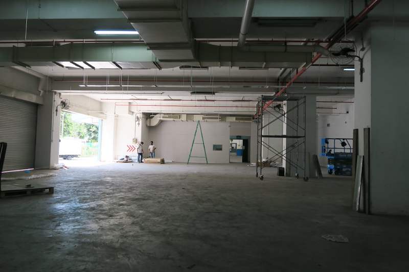 Before: empty warehouse unit with scaffold tower and ladder during fit-out - Boltless Racking - B7 | Wong Lye Racking, Singapore Racking Manufacturer