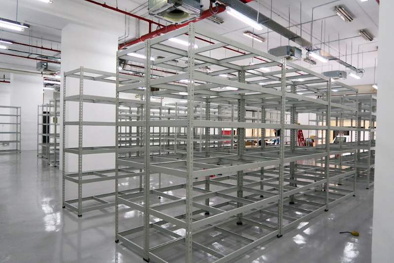 Blocks of beige boltless shelving with five levels on the epoxy floor, shelves empty - Boltless Racking - B7 | Wong Lye Racking, Singapore Racking Manufacturer