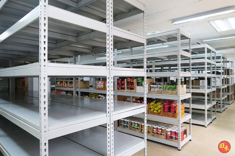 Boltless shelving rows with bagged snacks and cans on the far bay, near bays empty - Boltless Racking - B2 | Wong Lye Racking, Singapore Racking Manufacturer