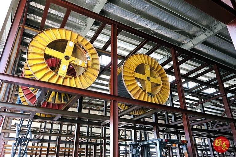 Cable drums seated in the red-oxide primed steel racking frame during installation - V10000 Racking - V10-1 | Wong Lye Racking, Singapore Racking Manufacturer