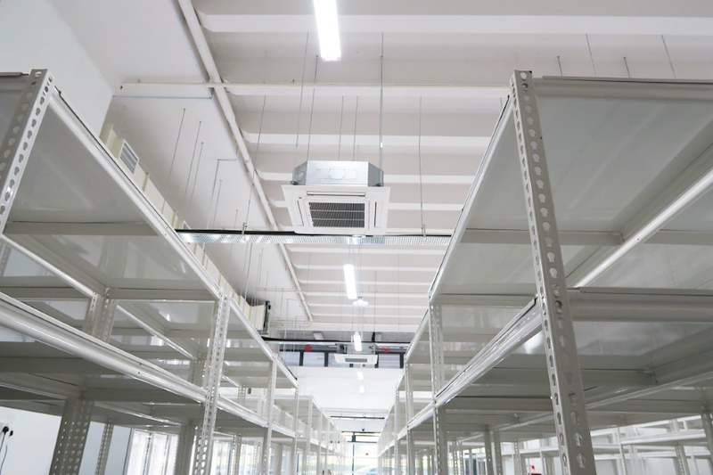 Looking up between white boltless shelving rows to ceiling cassette air-conditioning units - Boltless Racking - B8 | Wong Lye Racking, Singapore Racking Manufacturer
