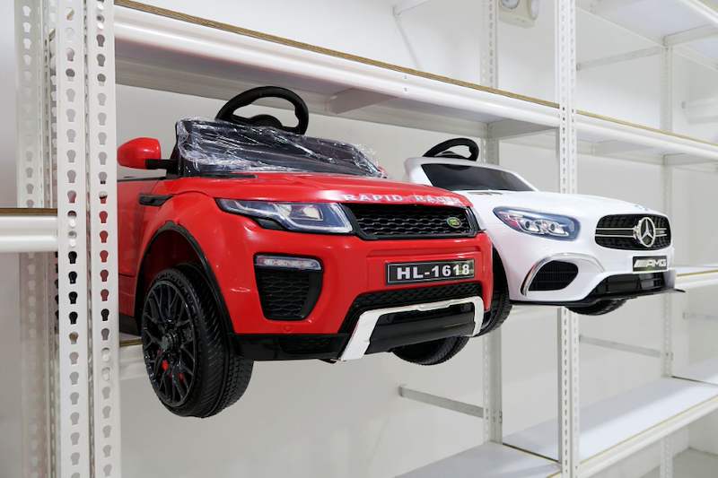 Red ride-on toy car on a boltless shelf with a white toy car behind it - Boltless Racking - B3 | Wong Lye Racking, Singapore Racking Manufacturer