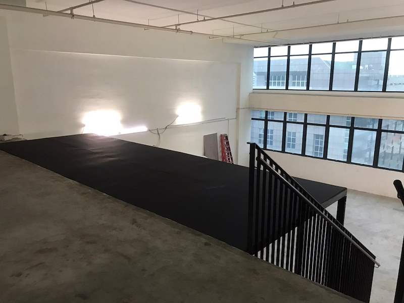 Upper mezzanine deck being fitted with dark deck panels, black balustrade at the stair opening - V5000 Racking - V5-9 | Wong Lye Racking, Singapore Racking Manufacturer