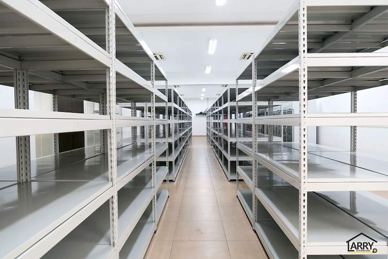 Aisle between rows of grey boltless shelving with five steel shelf levels, all empty - Boltless Racking - B5 | Wong Lye Racking, Singapore Racking Manufacturer