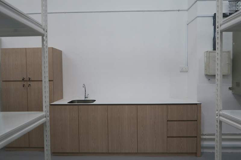 Pantry counter and cabinets against the wall, boltless shelving on either side - Boltless Racking - B8 | Wong Lye Racking, Singapore Racking Manufacturer