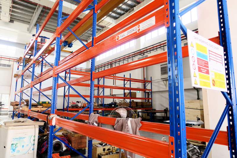 V3000 racking run with orange beams and blue uprights, load chart on the end frame - V3000 Racking - V3-5 | Wong Lye Racking, Singapore Racking Manufacturer