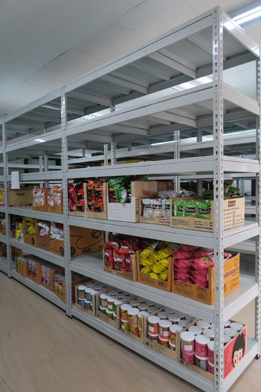 Boltless shelving bay stocked with bagged snacks and rows of canned goods - Boltless Racking - B2 | Wong Lye Racking, Singapore Racking Manufacturer