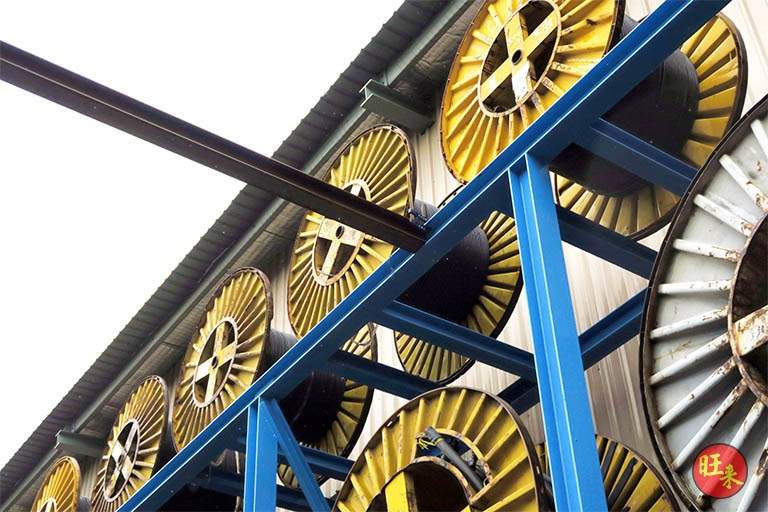 Looking up at the blue steel beams of the V10000 racking with cable drums above - V10000 Racking - V10-1 | Wong Lye Racking, Singapore Racking Manufacturer
