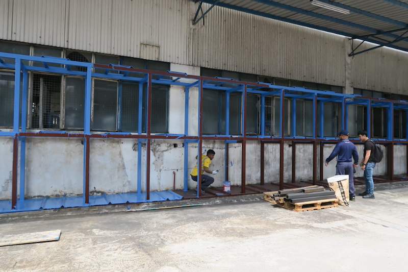 Angled view of the two-tier rack frame under construction, installers checking the base - V5000 Racking - V5-1 | Wong Lye Racking, Singapore Racking Manufacturer