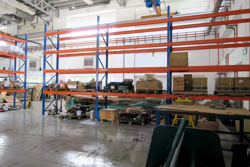 V3000 racking run across the workshop with equipment stored on the floor in front - V3000 Racking - V3-5 | Wong Lye Racking, Singapore Racking Manufacturer