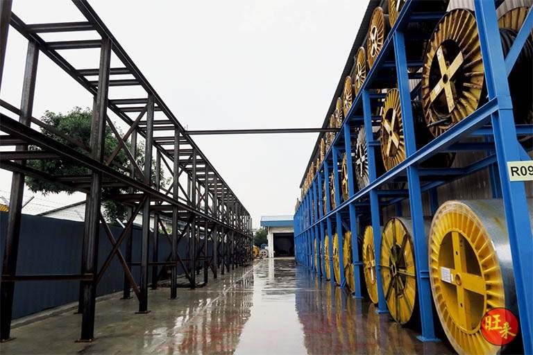 Outdoor run of V10000 racking beside a yard, steel structure extending along the site - V10000 Racking - V10-1 | Wong Lye Racking, Singapore Racking Manufacturer