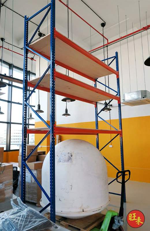 Tall V3000 racking bay with three plywood levels against the orange wall, palletised item on the floor - V3000 Racking - V3-4 | Wong Lye Racking, Singapore Racking Manufacturer