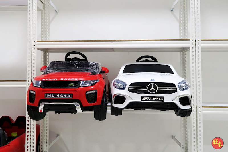 Red and white ride-on toy cars side by side on a white boltless shelf - Boltless Racking - B3 | Wong Lye Racking, Singapore Racking Manufacturer