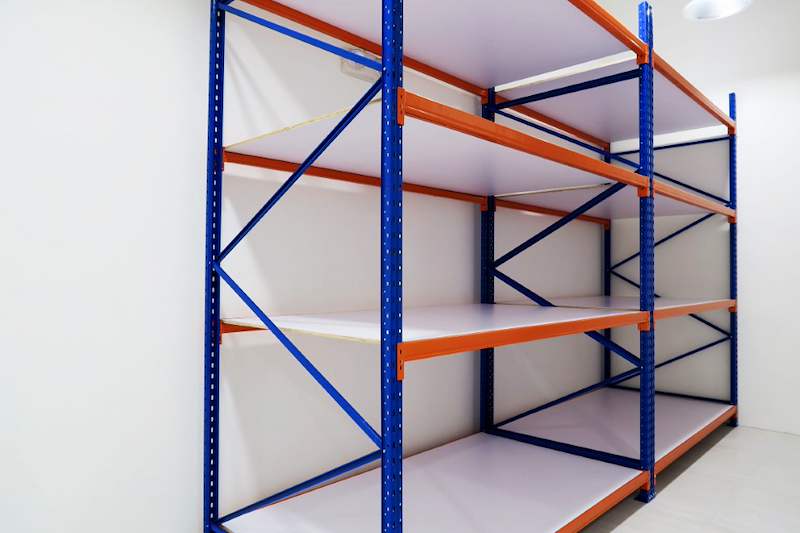 Two bays of blue-and-orange long-span racking with white board decking, bays empty - Boltless Racking - B3 | Wong Lye Racking, Singapore Racking Manufacturer