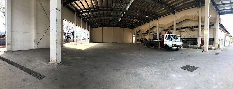 Before: empty covered yard with a concrete floor and a lorry parked at the far end - V10000 Racking - V10-1 | Wong Lye Racking, Singapore Racking Manufacturer