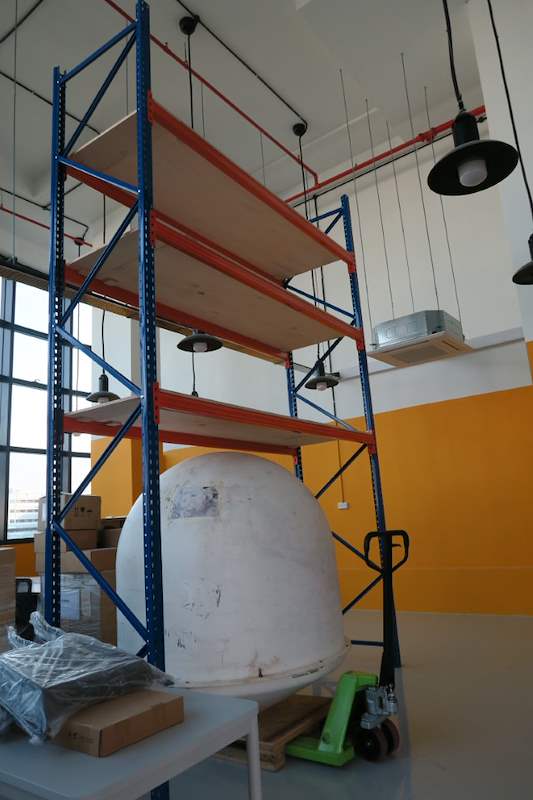 Tall V3000 racking bay with plywood decks reaching toward the ceiling, palletised item and pallet truck below - V3000 Racking - V3-4 | Wong Lye Racking, Singapore Racking Manufacturer