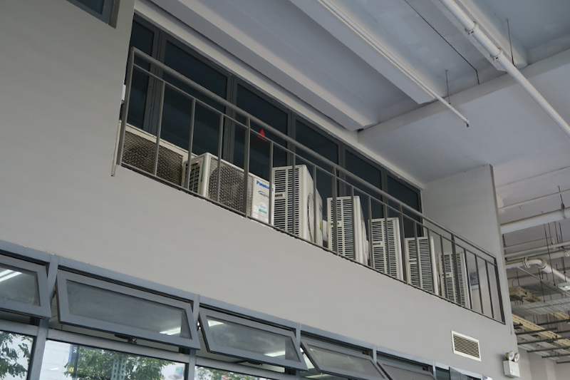 Air-conditioning condenser units on a railed ledge above the store windows - Boltless Racking - B8 | Wong Lye Racking, Singapore Racking Manufacturer