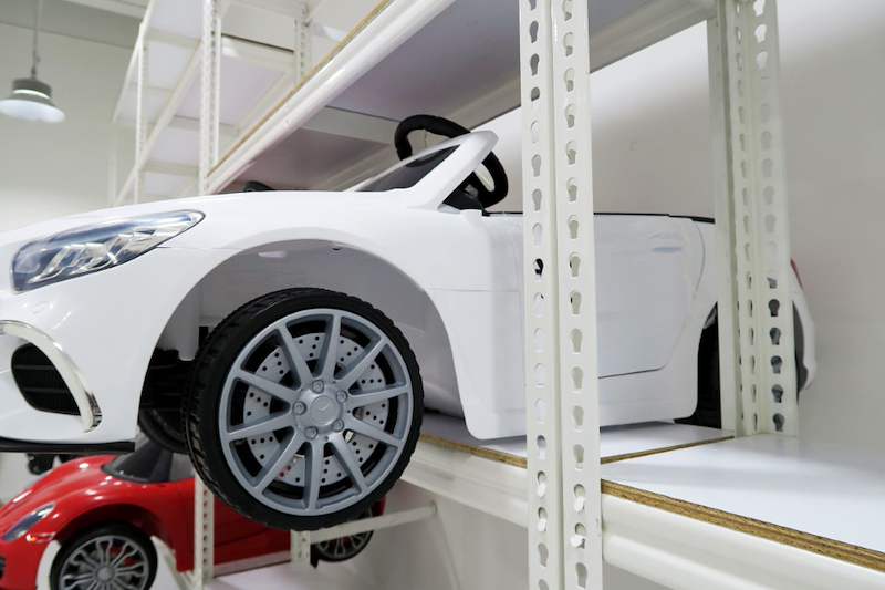 White ride-on toy car on a boltless shelf with a red toy car on the level below - Boltless Racking - B3 | Wong Lye Racking, Singapore Racking Manufacturer