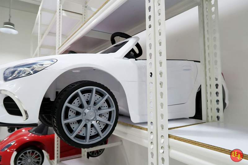 White ride-on toy car on a boltless shelf beside a slotted upright, red toy car below - Boltless Racking - B3 | Wong Lye Racking, Singapore Racking Manufacturer