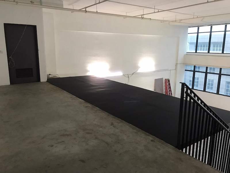 Mezzanine deck panels laid on the platform, black balustrade around the stair opening, windows beyond - V5000 Racking - V5-9 | Wong Lye Racking, Singapore Racking Manufacturer