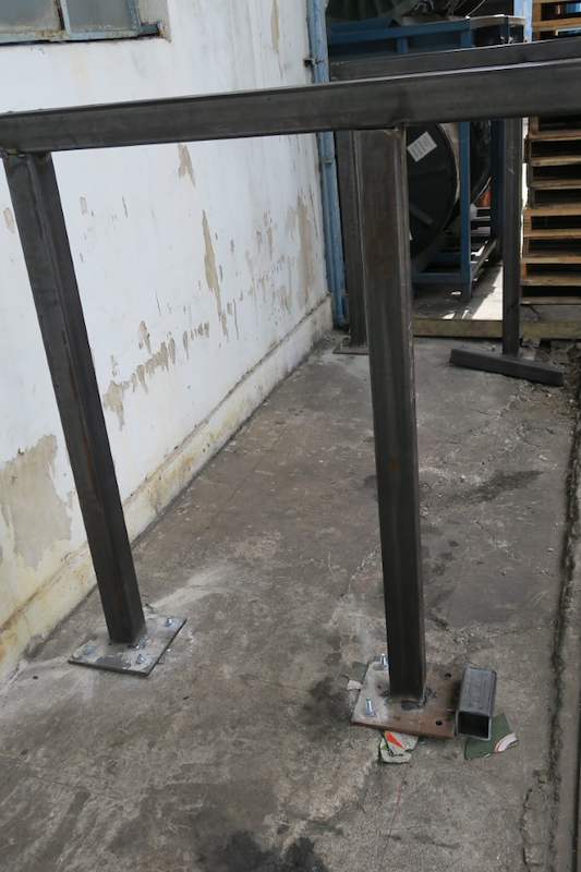 First uprights and top beam of the drum rack fitted along the wall, base plates bolted down - V5000 Racking - V5-1 | Wong Lye Racking, Singapore Racking Manufacturer