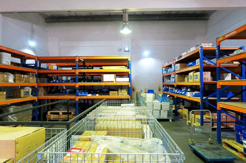 Aisle on the mezzanine deck between wire cages and blue-and-orange racking full of cartons - V5000 Racking - V5-8 | Wong Lye Racking, Singapore Racking Manufacturer