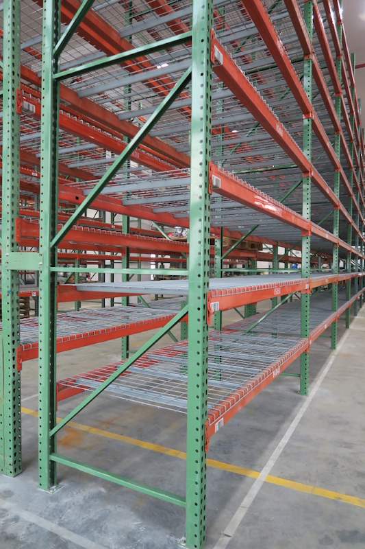 End frame of a pallet racking run showing green upright bracing and mesh decks - V3000 Racking - V3-3 | Wong Lye Racking, Singapore Racking Manufacturer