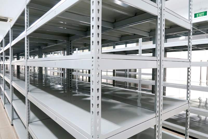 Grey boltless shelving with slotted uprights and steel shelf panels, viewed along the row - Boltless Racking - B5 | Wong Lye Racking, Singapore Racking Manufacturer