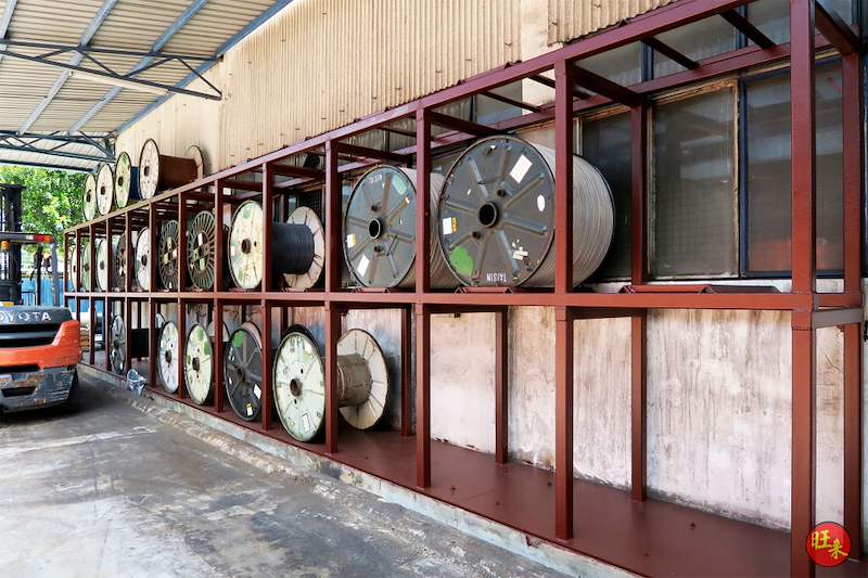 Completed two-tier welded steel rack in red-oxide finish holding cable drums under the shed roof, forklift at the end - V5000 Racking - V5-1 | Wong Lye Racking, Singapore Racking Manufacturer