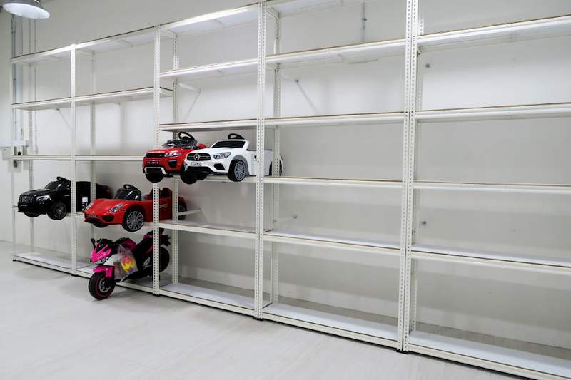 Long run of white boltless shelving with five levels along the wall, toy cars on the lower bays - Boltless Racking - B3 | Wong Lye Racking, Singapore Racking Manufacturer