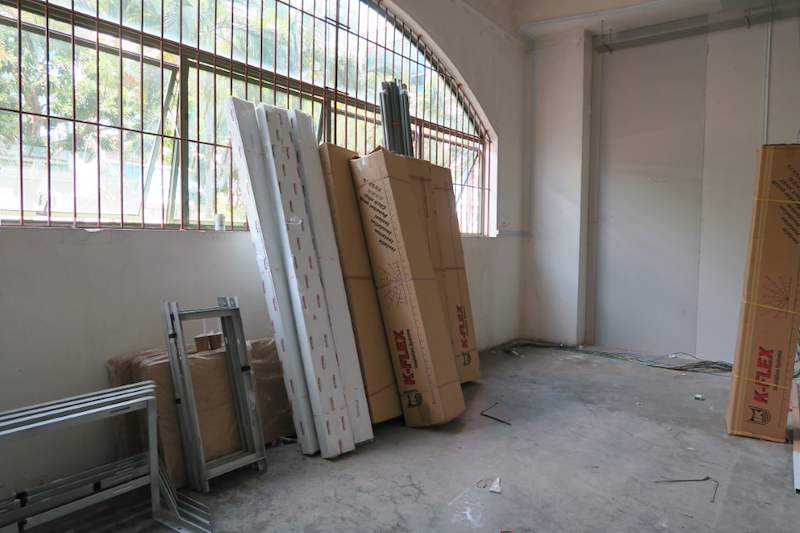 Before: packed panels and materials stacked against the wall by the window before installation - Boltless Racking - B7 | Wong Lye Racking, Singapore Racking Manufacturer