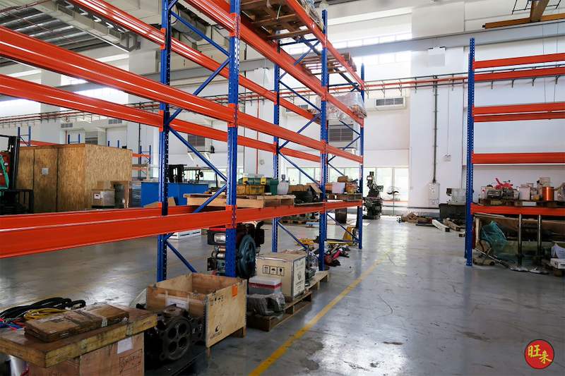 V3000 racking runs across the workshop with crates and parts stored beneath - V3000 Racking - V3-5 | Wong Lye Racking, Singapore Racking Manufacturer