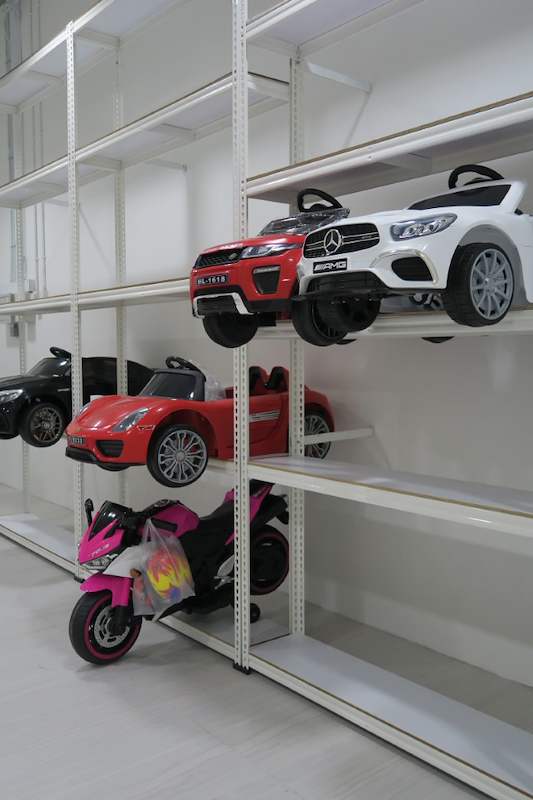 White boltless shelving run with ride-on toy cars and a toy motorcycle on the lower levels - Boltless Racking - B3 | Wong Lye Racking, Singapore Racking Manufacturer