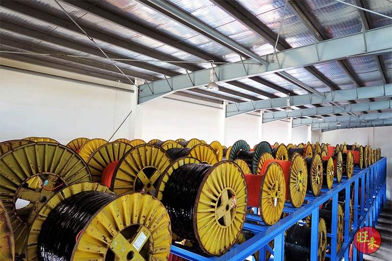 Rows of cable drums on the V10000 racking in a shed with a steel roof - V10000 Racking - V10-1 | Wong Lye Racking, Singapore Racking Manufacturer