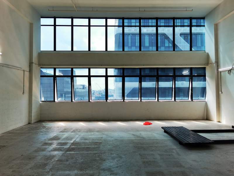 Window wall of the empty unit with a stack of deck panels on the floor - V5000 Racking - V5-9 | Wong Lye Racking, Singapore Racking Manufacturer