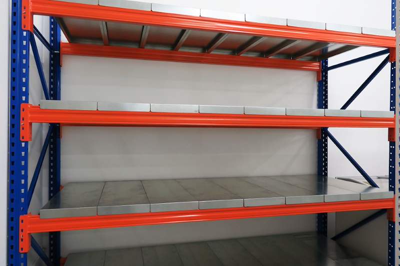 Front view of the long-span racking bay showing orange beams and steel deck panels on blue uprights - Boltless Racking - B8 | Wong Lye Racking, Singapore Racking Manufacturer