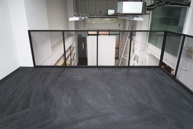 Empty mezzanine upper deck with mesh railing on three sides, ceiling ducting above - V5000 Racking - V5-16 | Wong Lye Racking, Singapore Racking Manufacturer