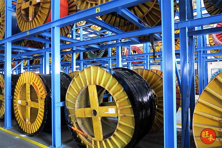 Cable drums on the lower tier of the V10000 racking beneath the blue steel beams - V10000 Racking - V10-1 | Wong Lye Racking, Singapore Racking Manufacturer